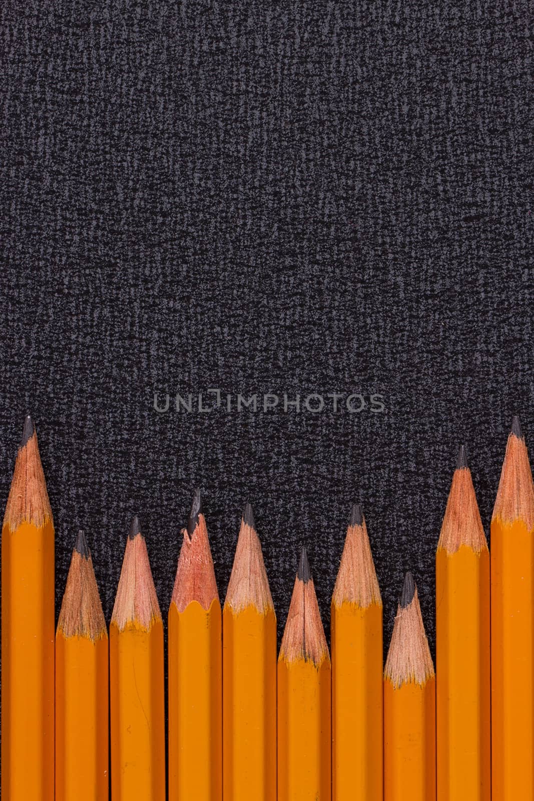 set of pencils on black background by victosha