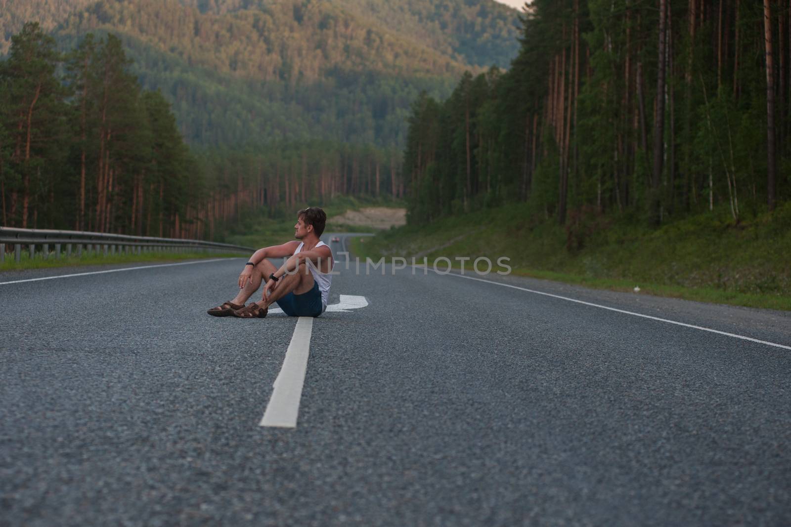 Man sitting on the road by rusak