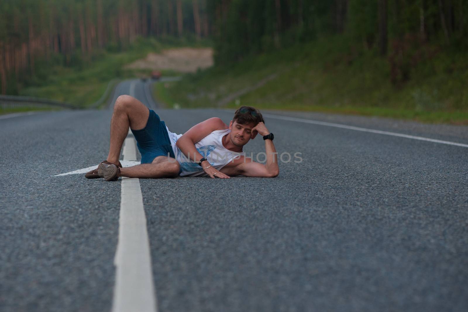 Man laying on the beauty road in mountain