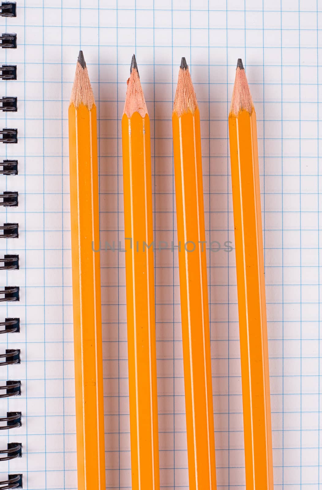 Opened notepad and colorful pencils on black background by victosha