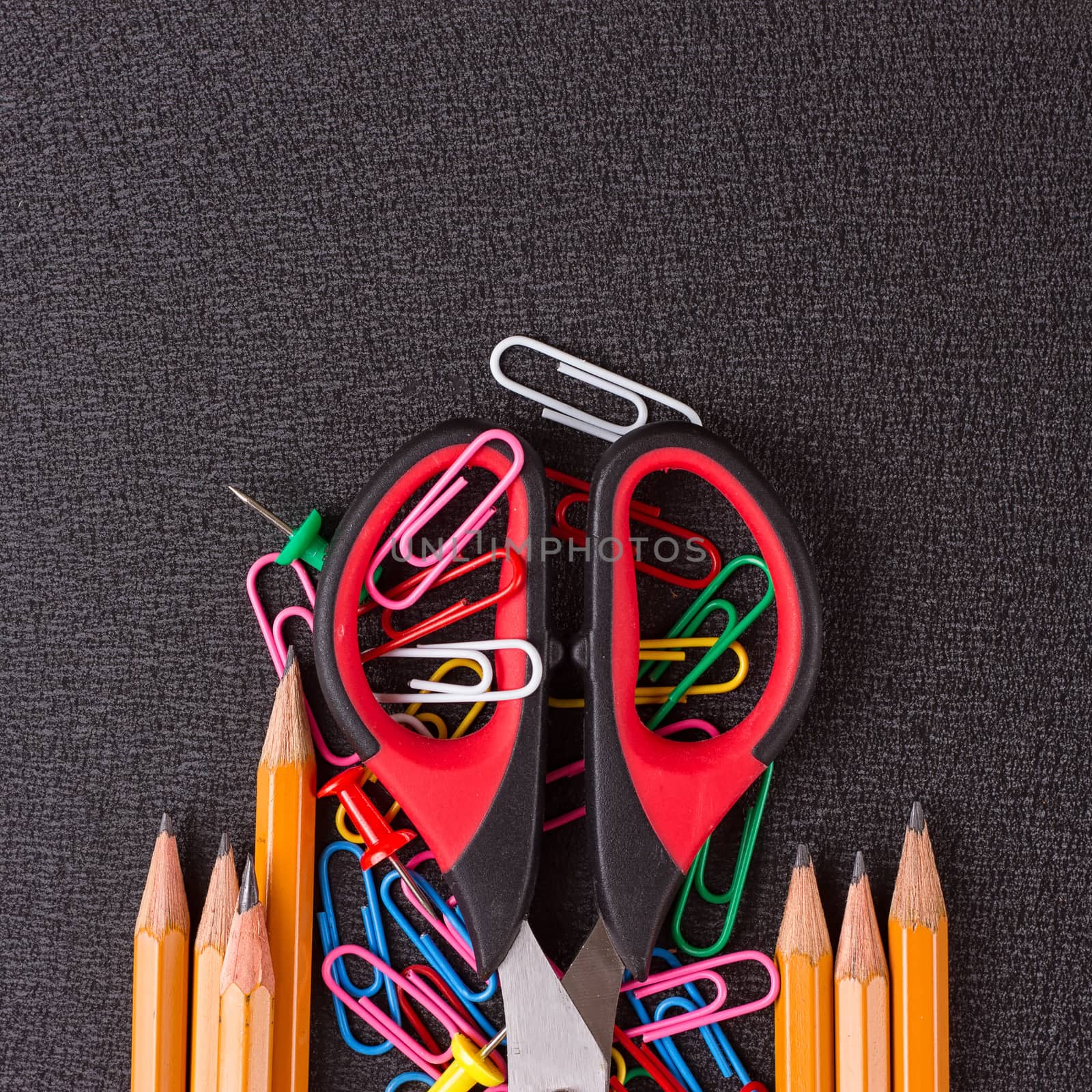 school supplies, stationery accessories on black background by victosha