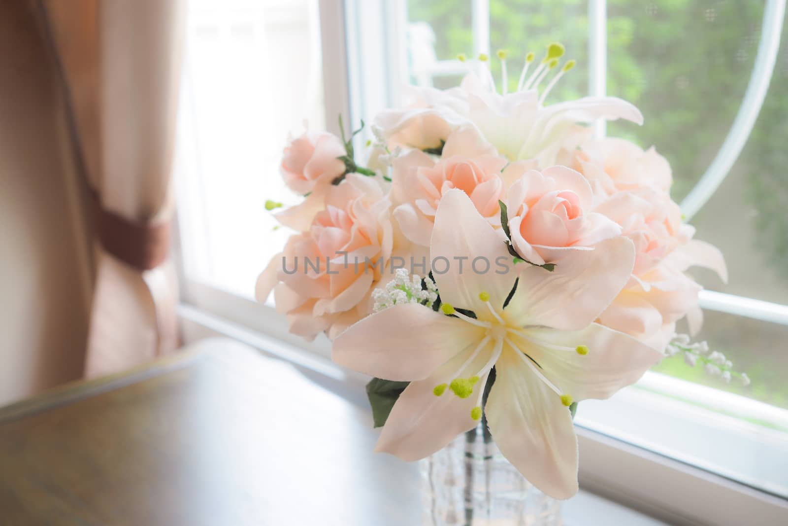 Flowers in a Glass Vase on table near window.