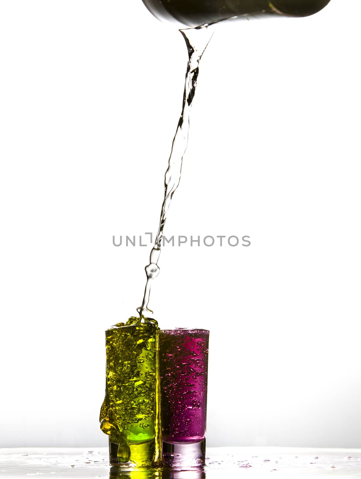 Liquid pouring into shot glasses