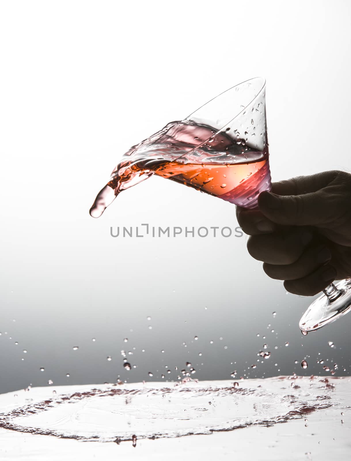 Cocktail being spilled out of a martini glass