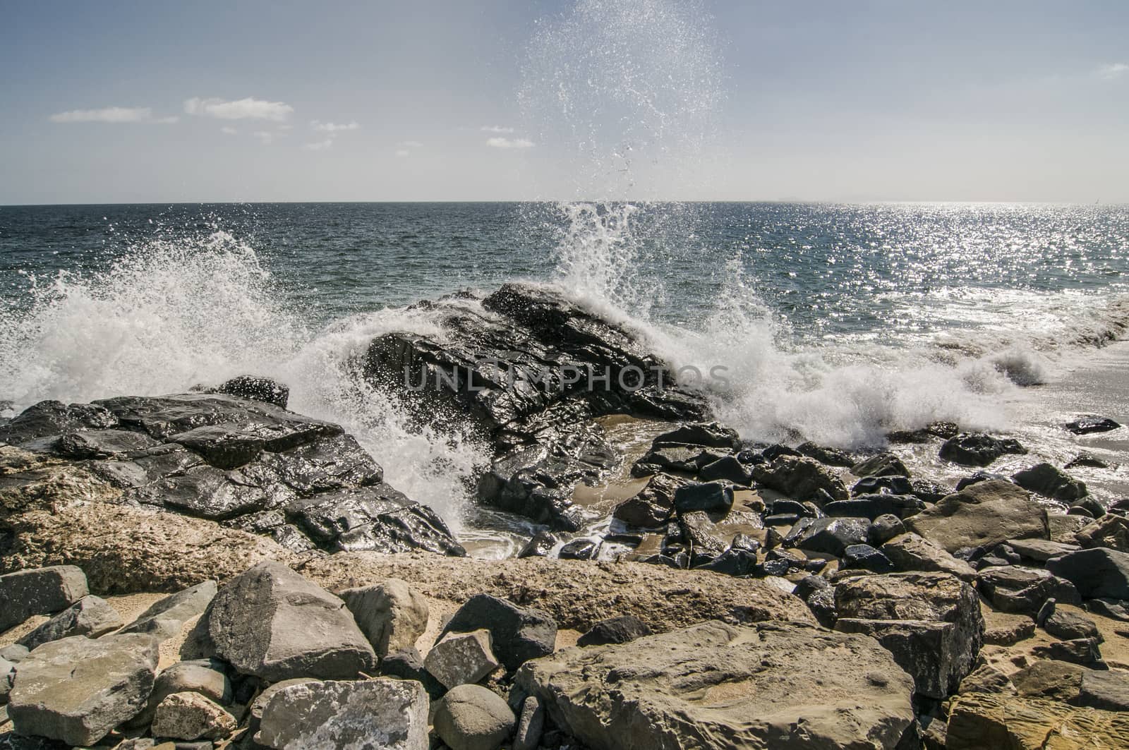 Waves crashing over rocks at Thornhill Broom beach in California by Njean