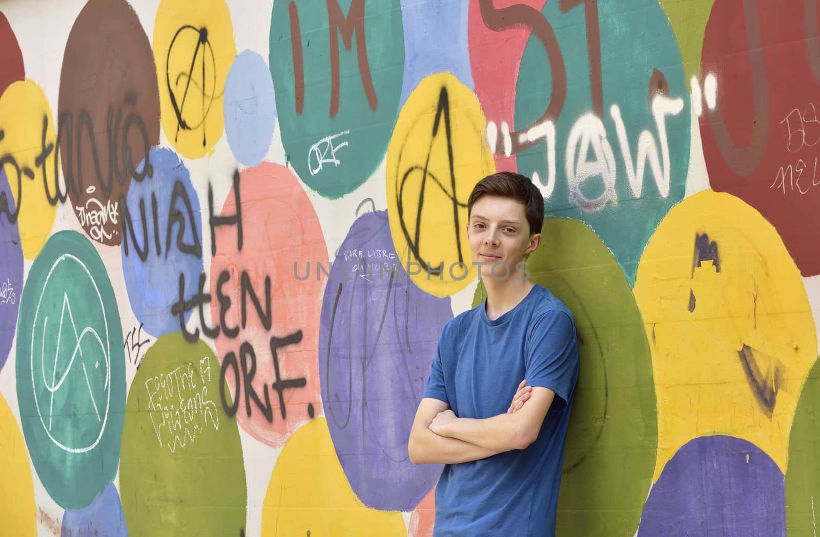 Teen boy near graffiti wall by jordachelr