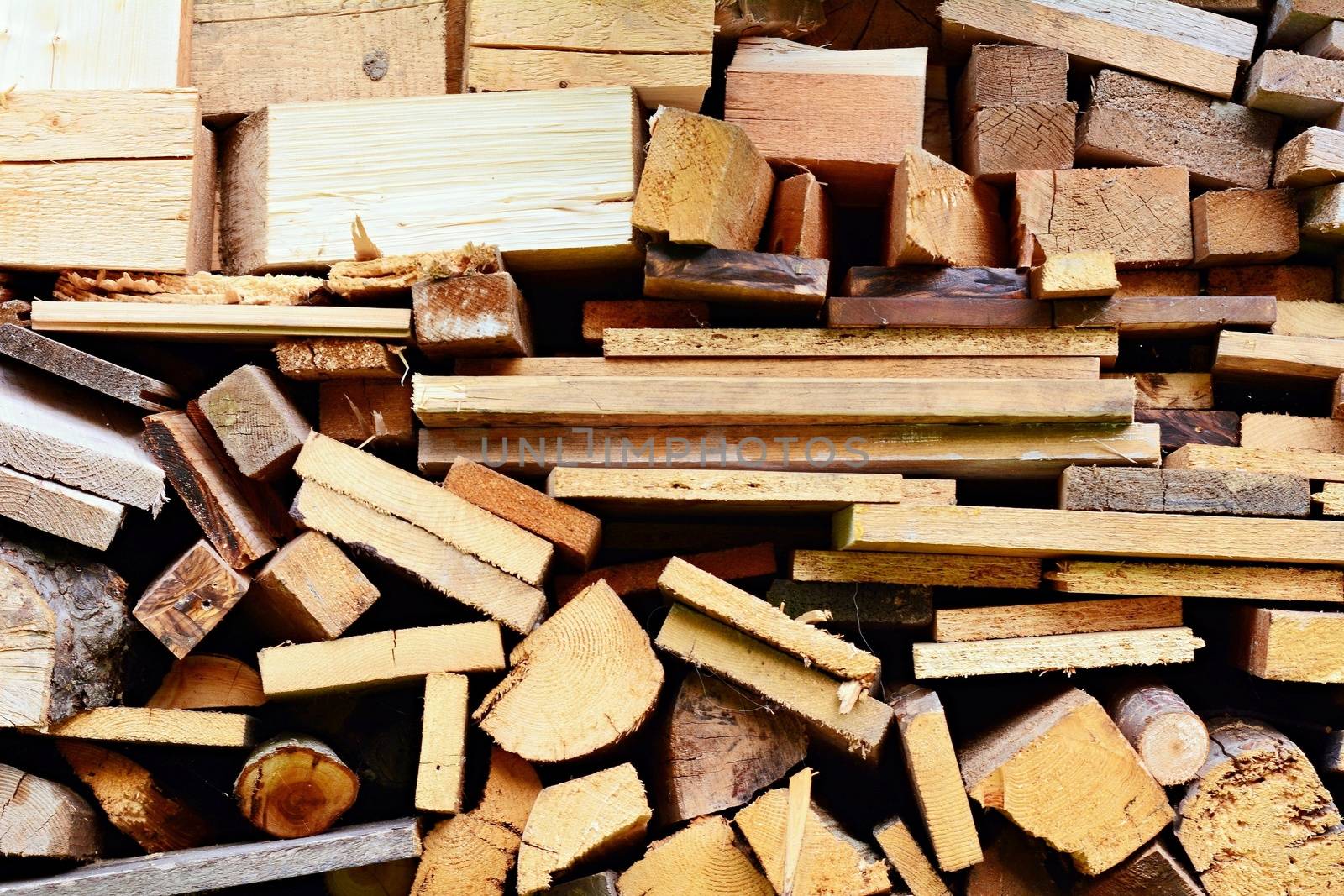 Background of timbers and logs stacked in woodshed.