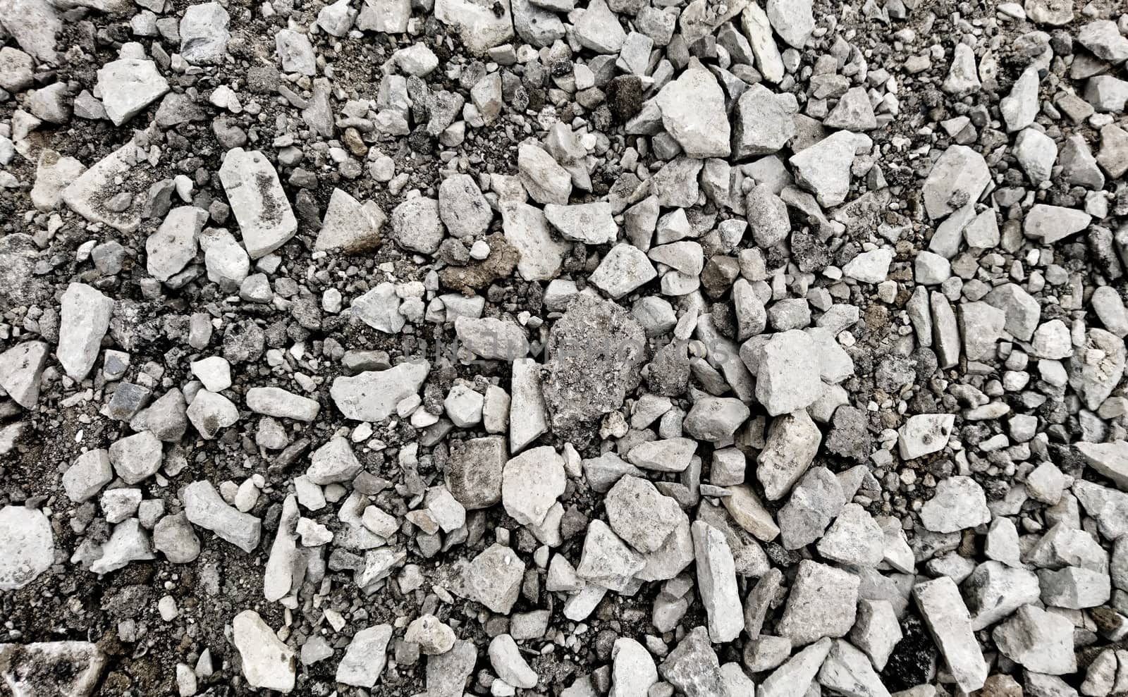 Top down view on a grey gravel stones texture. Background shot.