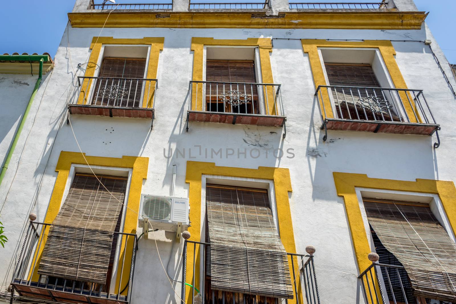 Cordoba, Spain - June 20 : The balcony of a house shaded by a st by ramana16