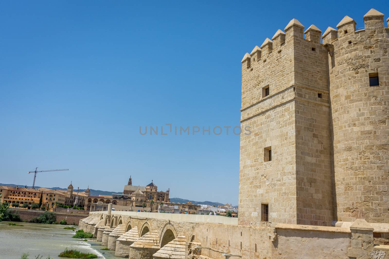 A view of the Calahorra tower, roman bridge and the Mezquita de Córdoba,the Great Mosque of Córdoba, Mosque-Cathedral,Mezquita and bell tower from the bridge on river Guadalquivir