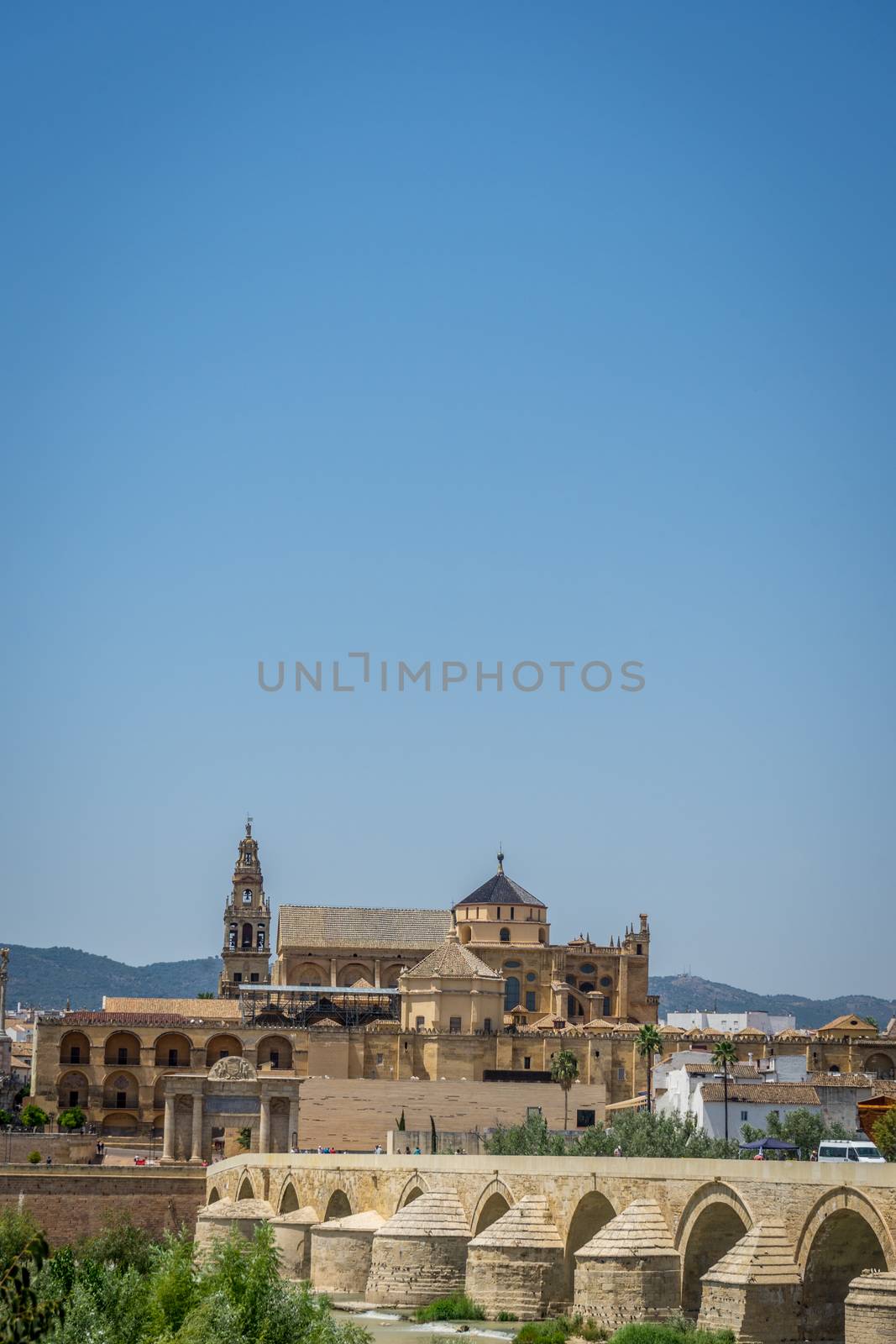 The roman bridge, bell tower and the Mezquita de Córdoba,the Great Mosque of Córdoba, Mosque-Cathedral,Mezquita of Cordoba across the Guadalquivir river, Spain, Europe, Andalucia