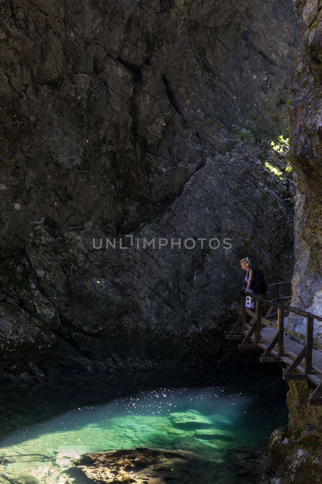 Woman hiking in Vintgar gorge in Slovenia near lake Bled. by kasto