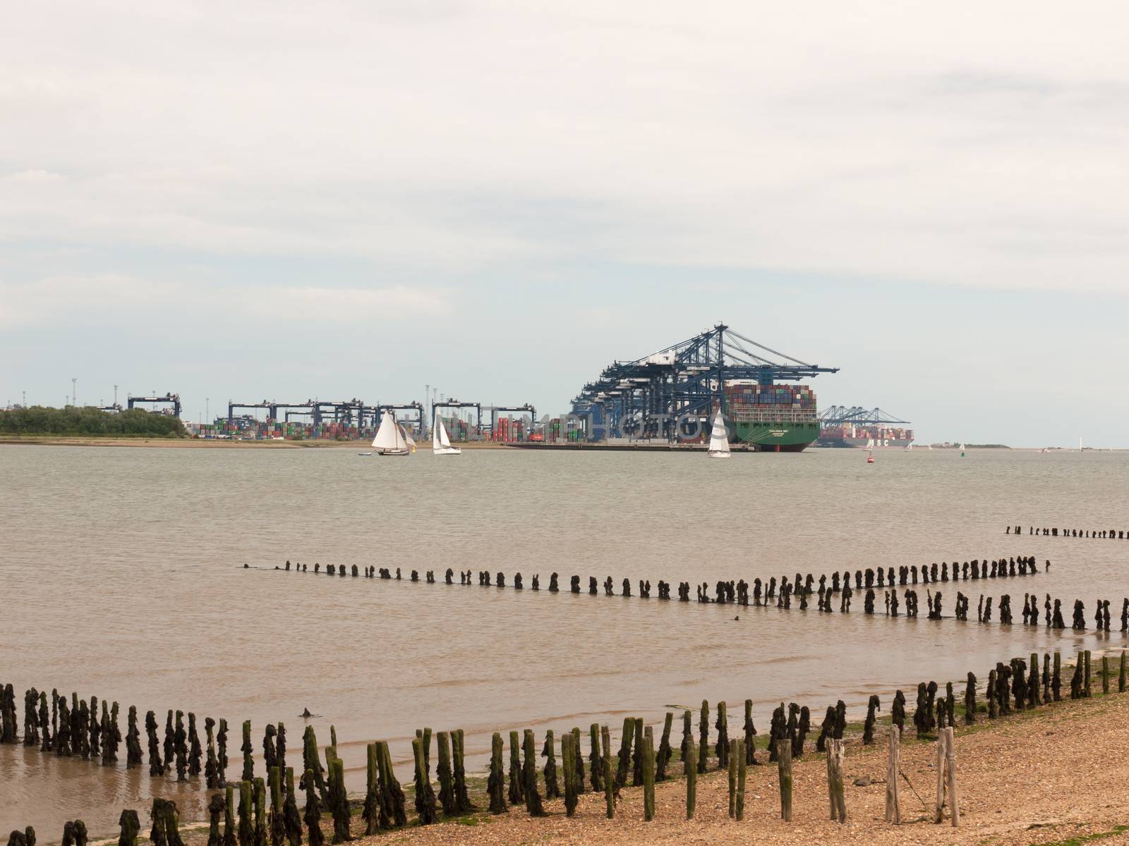 Stock Photo - blue sea structure cranes at cargo dock loading in by callumrc