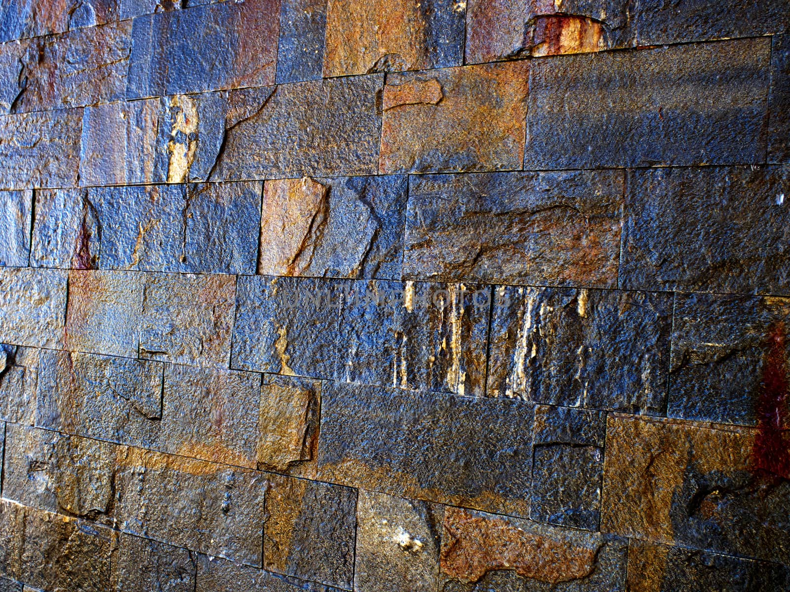Details of decorative stone wall in dark earth colors