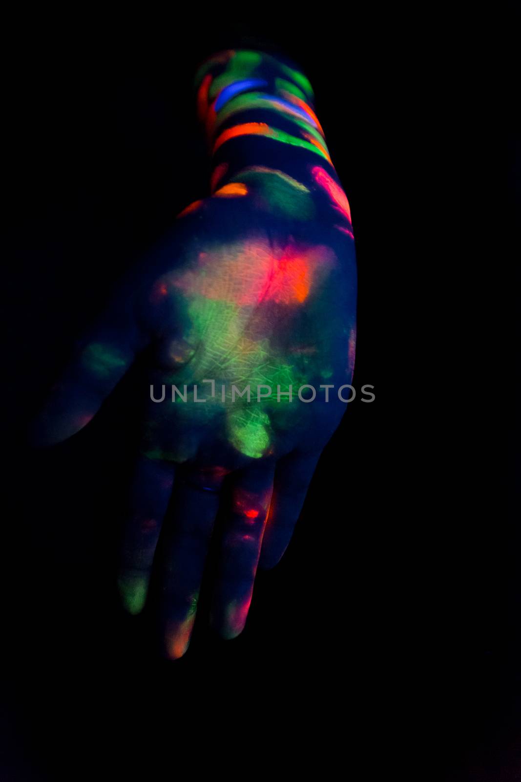 Woman with make up art of glowing UV fluorescent powder by wavemovies