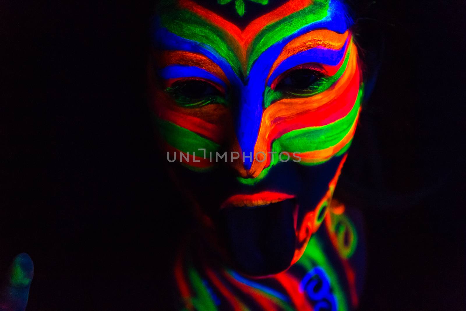 Woman with make up art of glowing UV fluorescent powder.