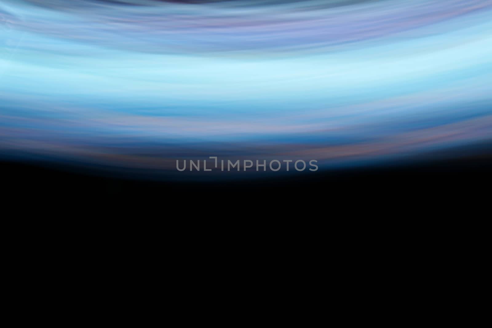 Glowing abstract curved lines.
Different colors.
Black background.
Done by long exposure technique