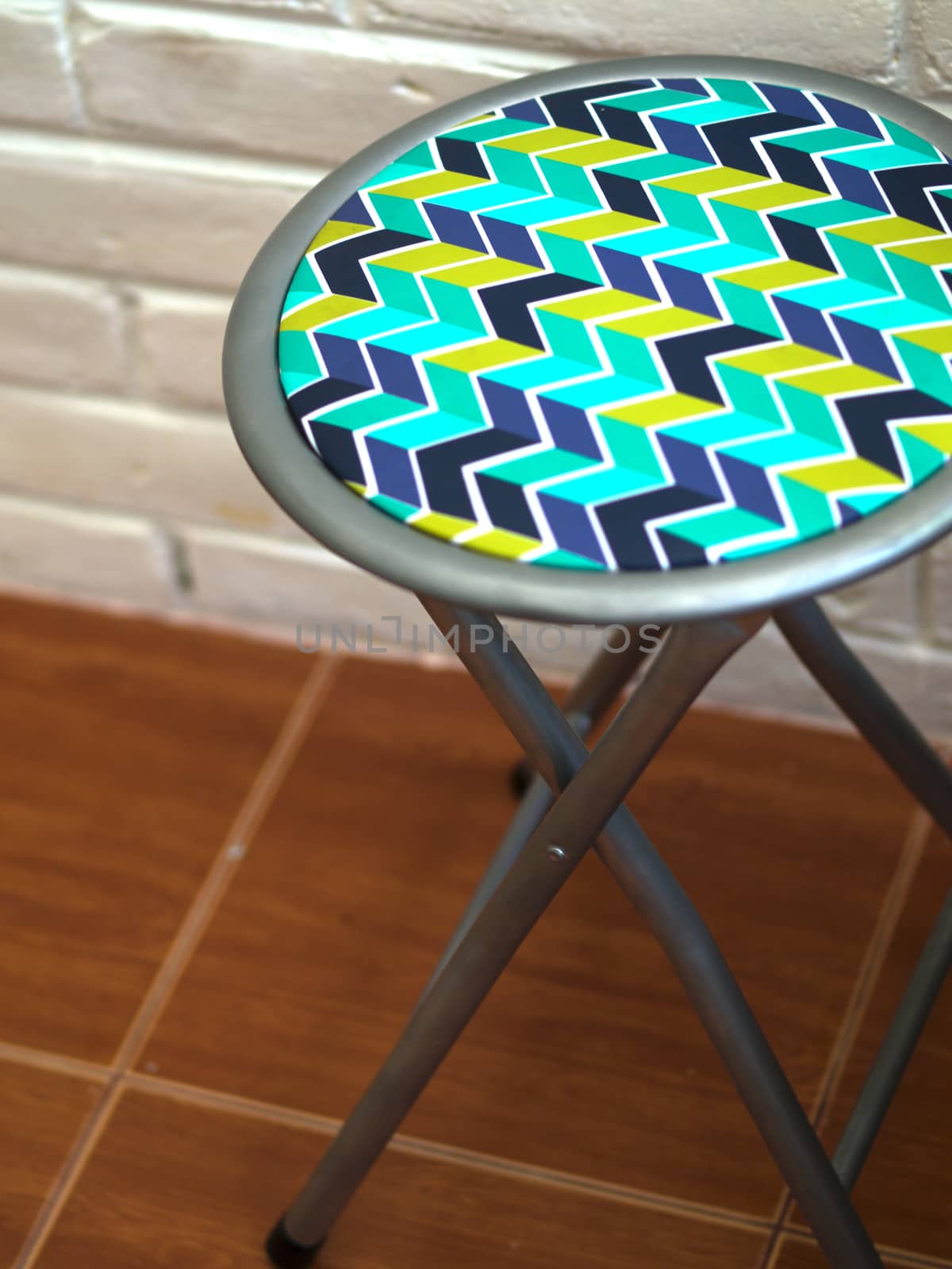 COLOR PHOTO OF STOOL WITH ZIG ZAG PATTERN LEATHER