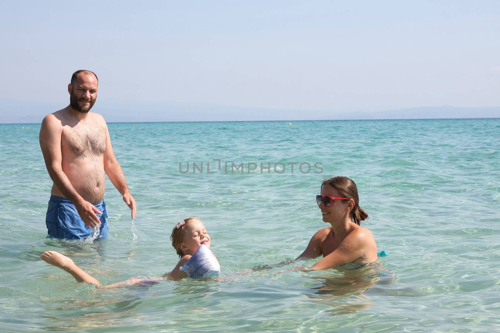 Father,mother and daughter in the sea by tdjoric