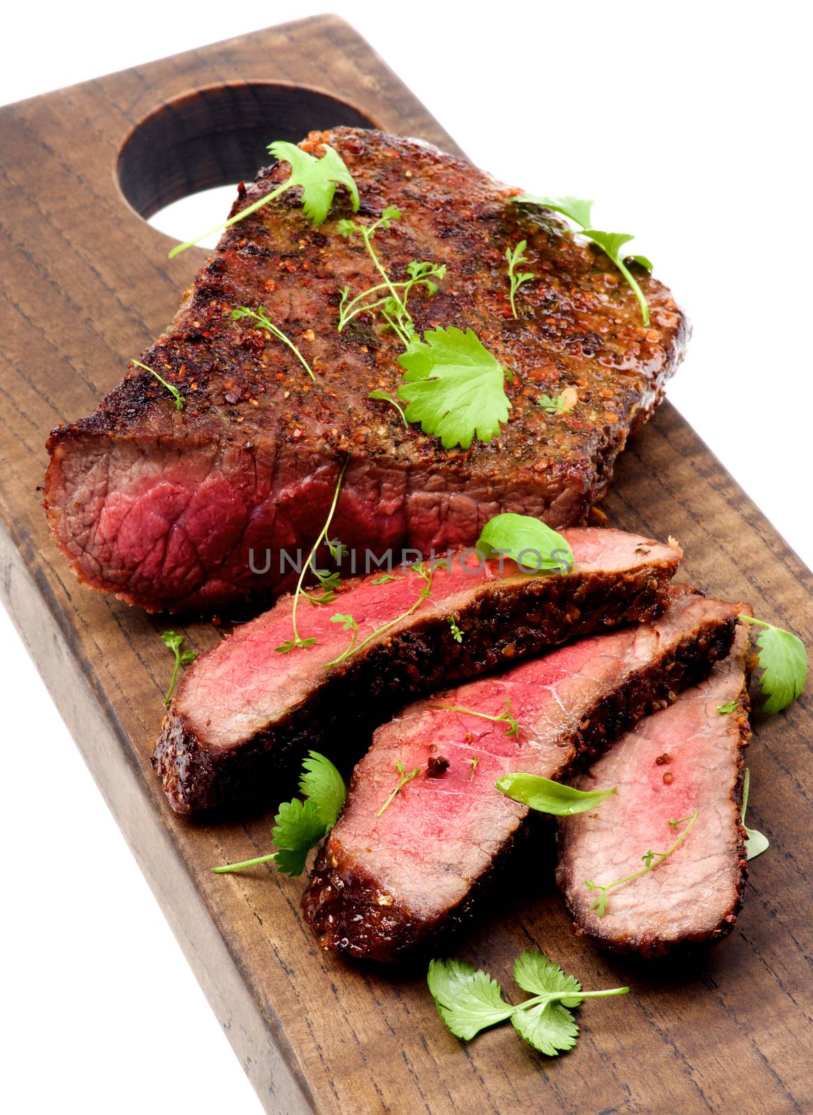 Delicious Roast Beef Medium Rare Sliced on Wooden Cutting Board isolated on White background