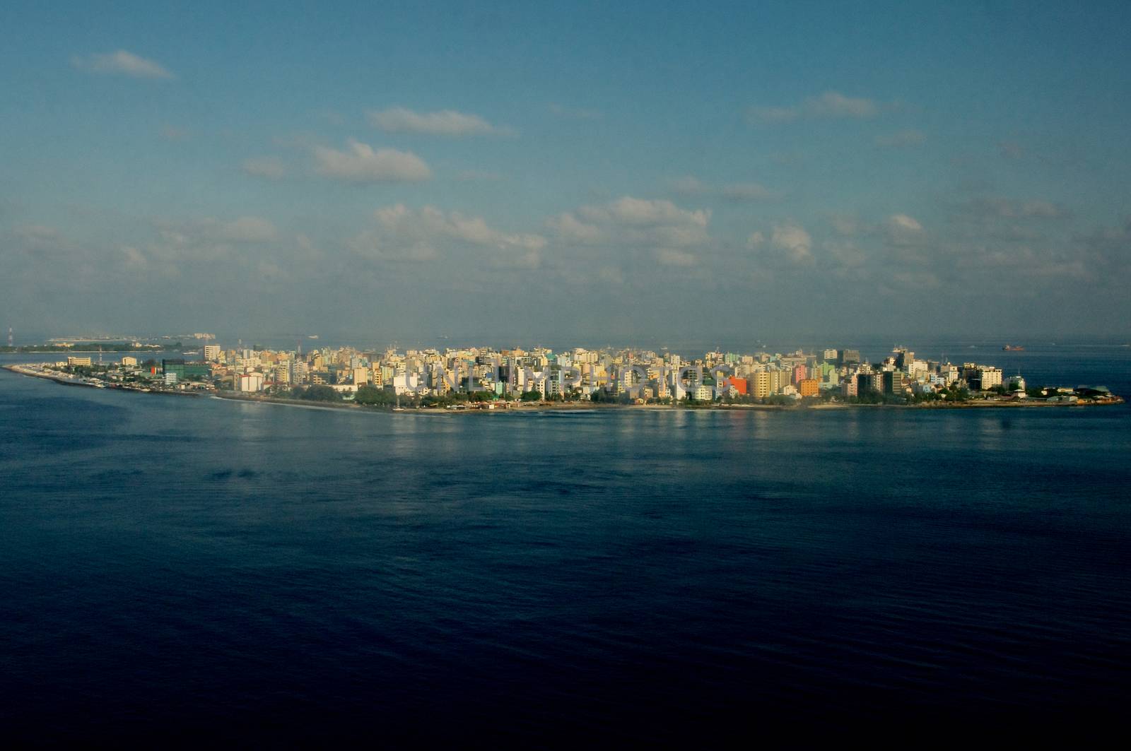 Aerial View of Male Maldivian Capital on Blue Sky with Clouds Early Morning Outdoors