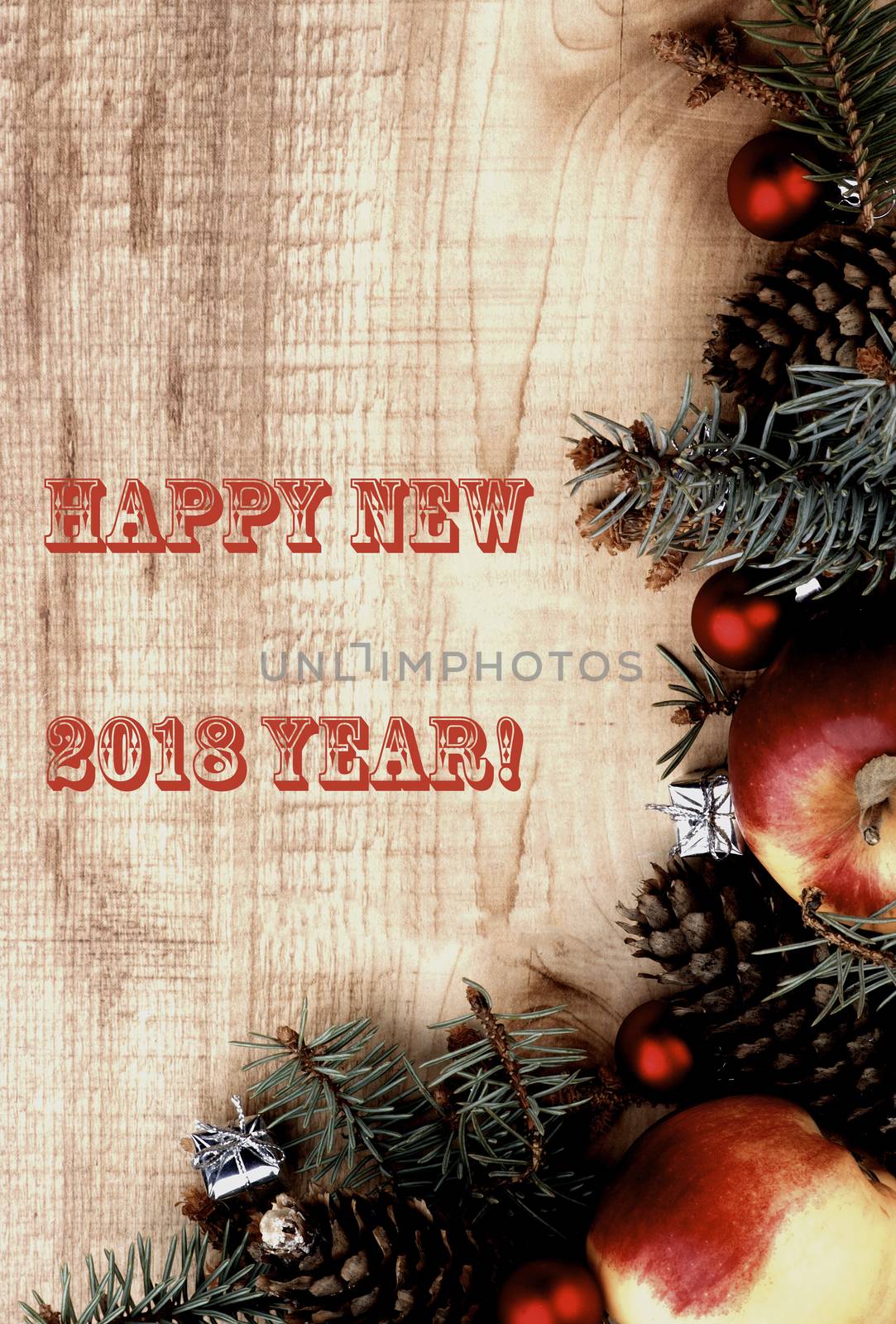 New Year Decoration with Spruce Branch, Red Baubles, Fir Cones, Apples and Inscription 2018 closeup on Wooden background