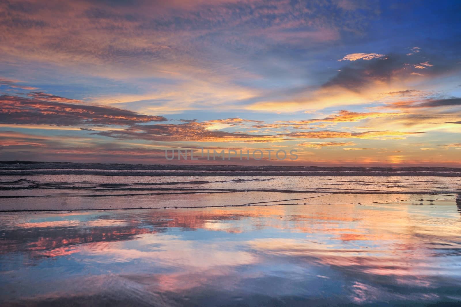 Beautiful clouds in blue sky with reflection in calm water in the morning lake. Nature wallpaper