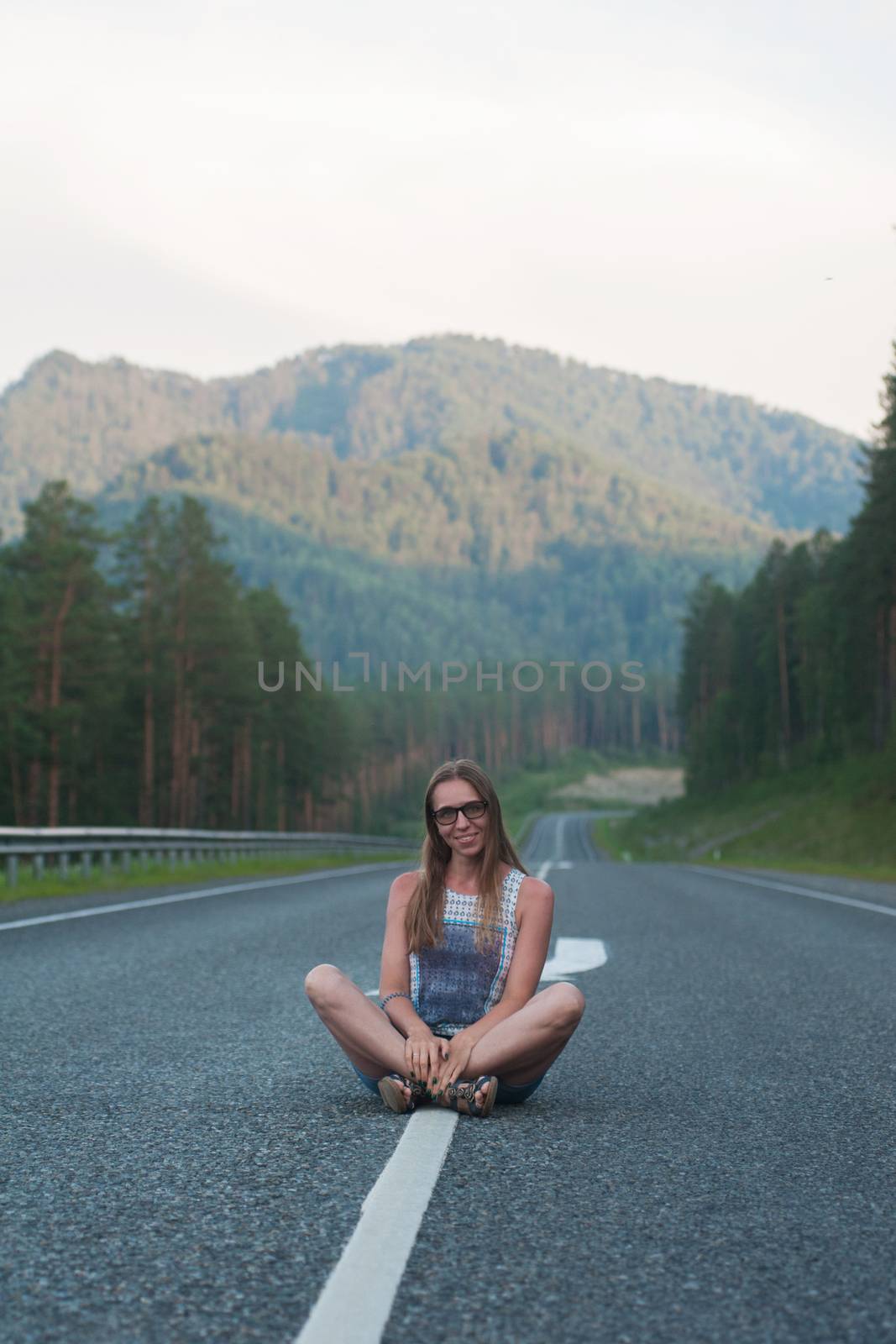 Woman sitting on the road by rusak