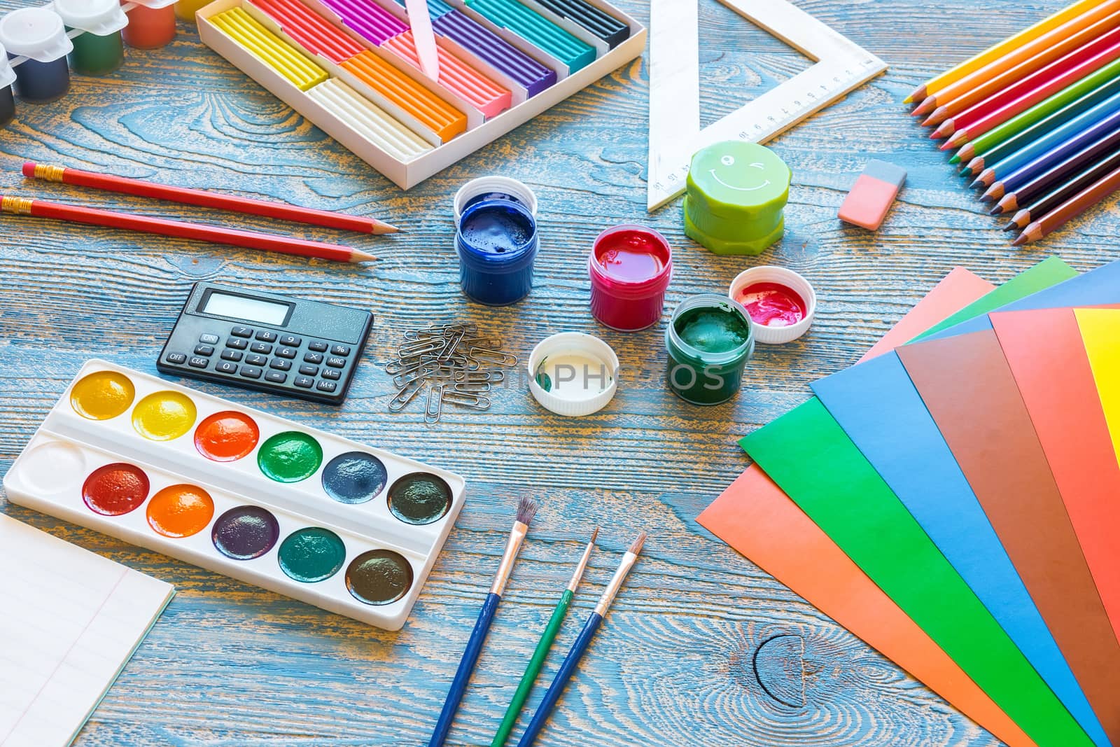 School supplies on a blue background by AlexBush