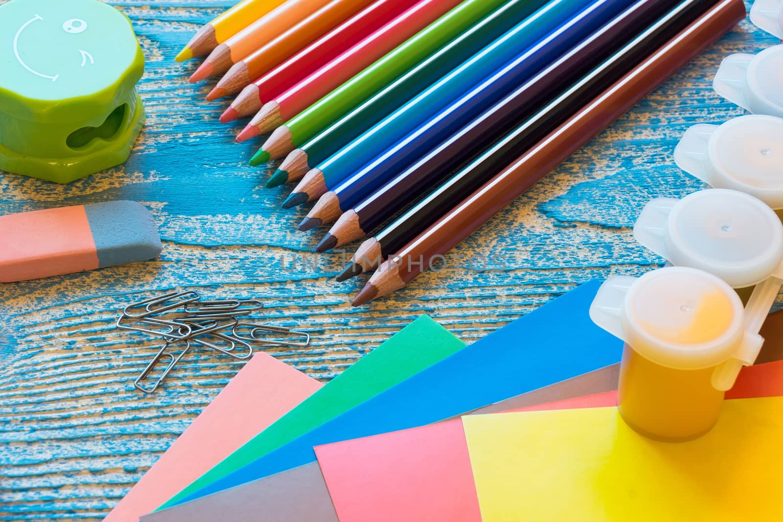 School supplies on a blue background, paints and brushes