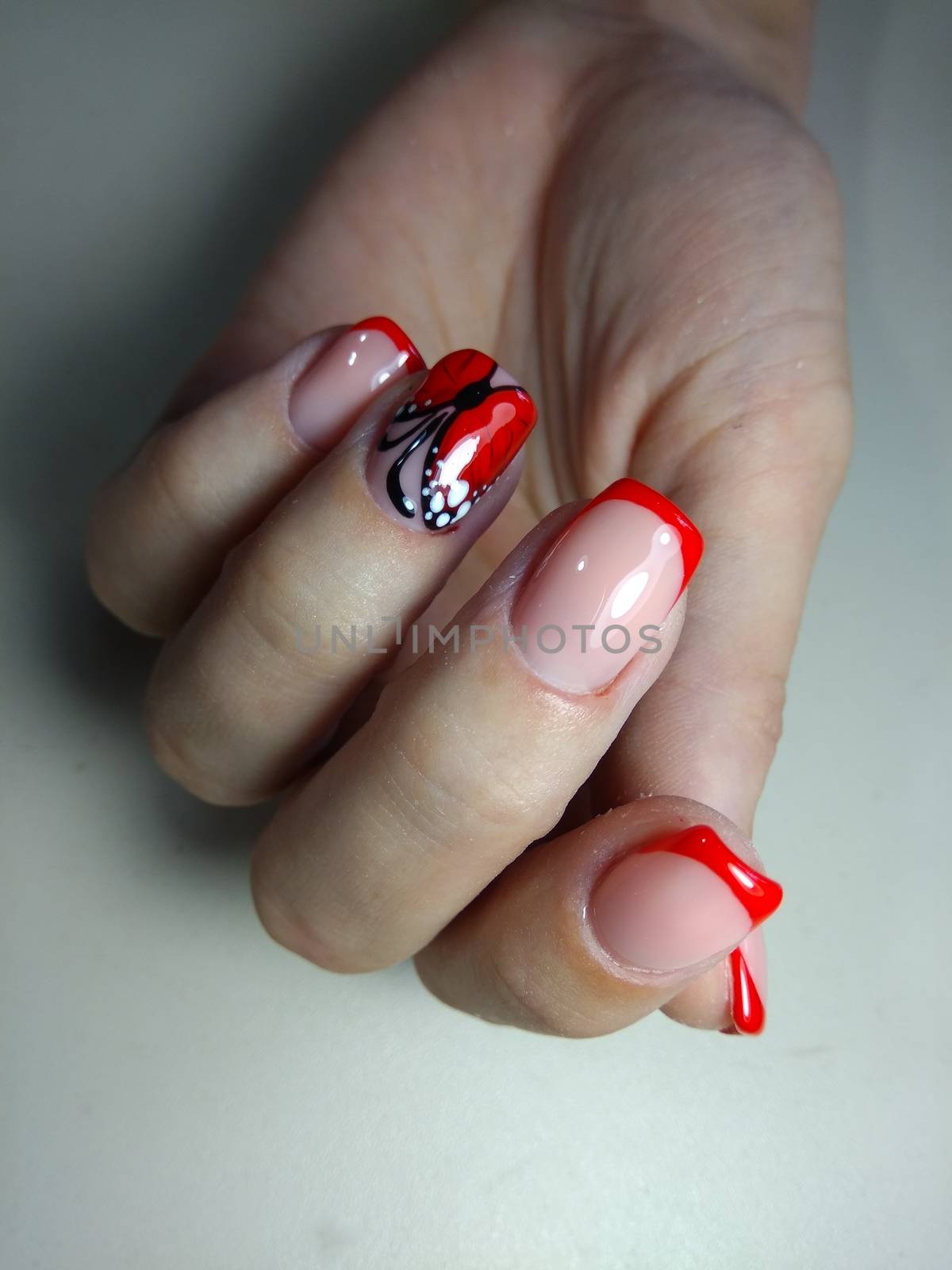 Beautiful manicure red butterfly by SmirMaxStock