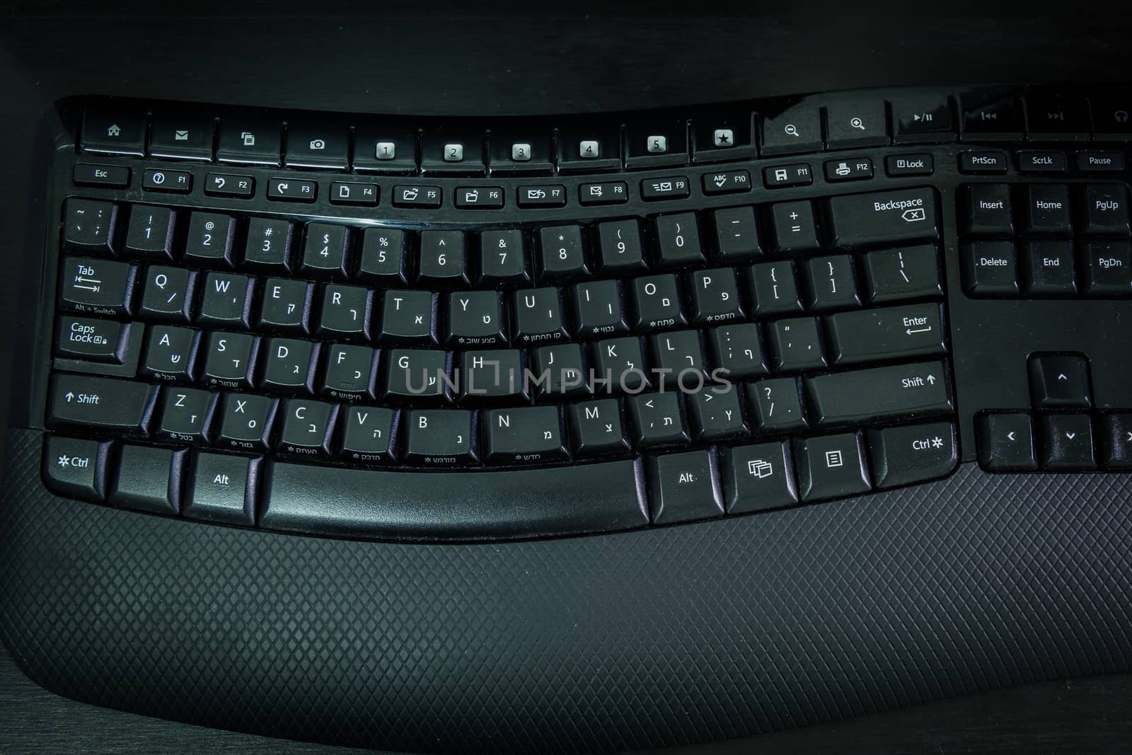 Keyboard with letters in Hebrew and English - Wireless keyboard - Top View -  Dark atmosphere