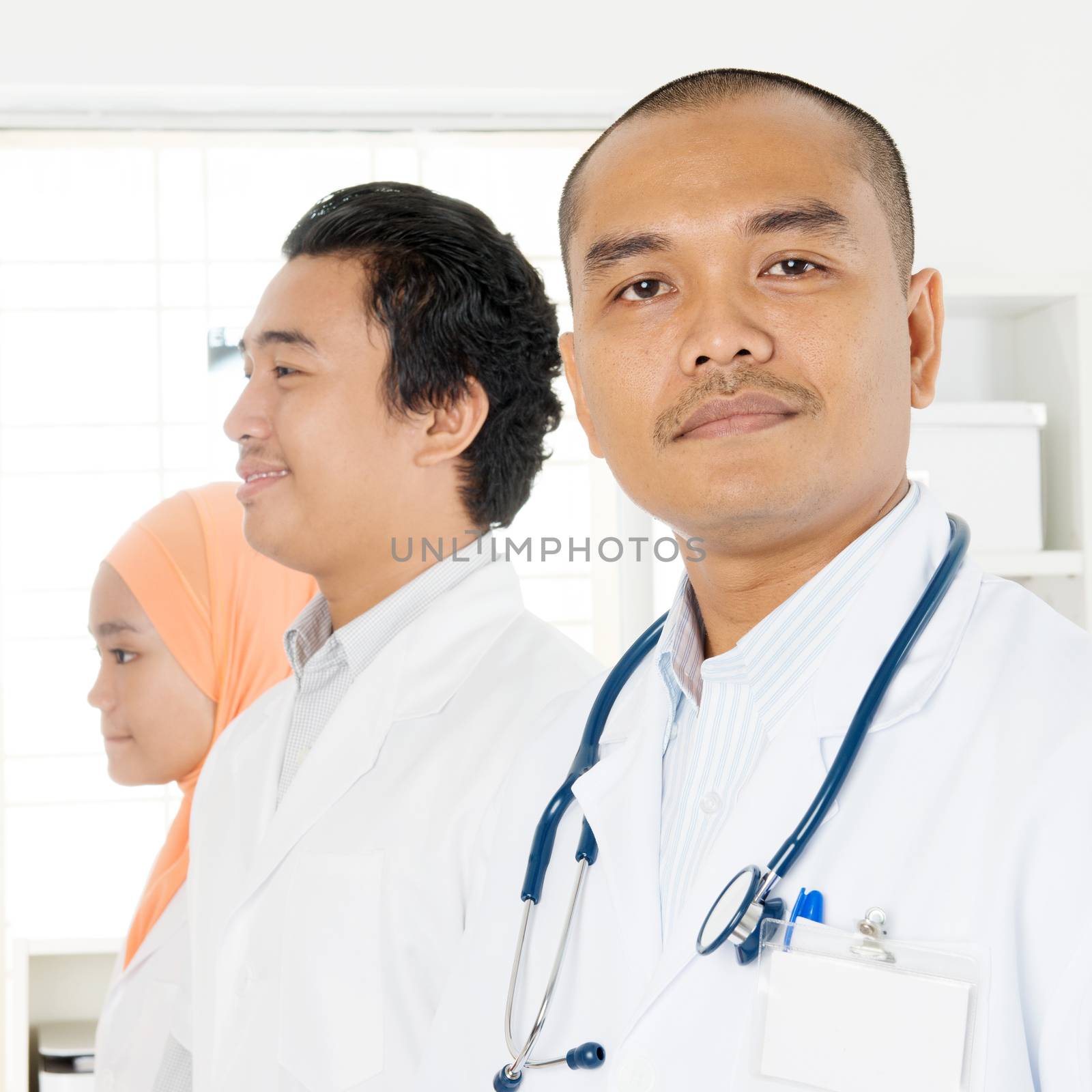 Portrait of medical team at hospital office, Southeast Asian Muslim doctors and nurses.