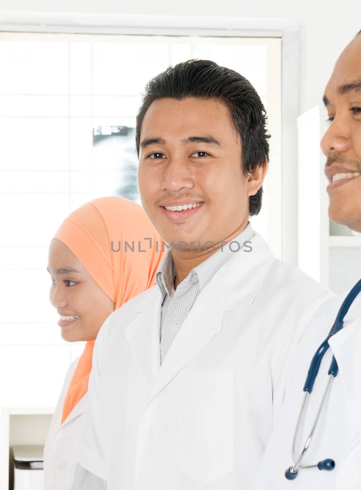Doctors group at hospital office, Southeast Asian Muslim people.