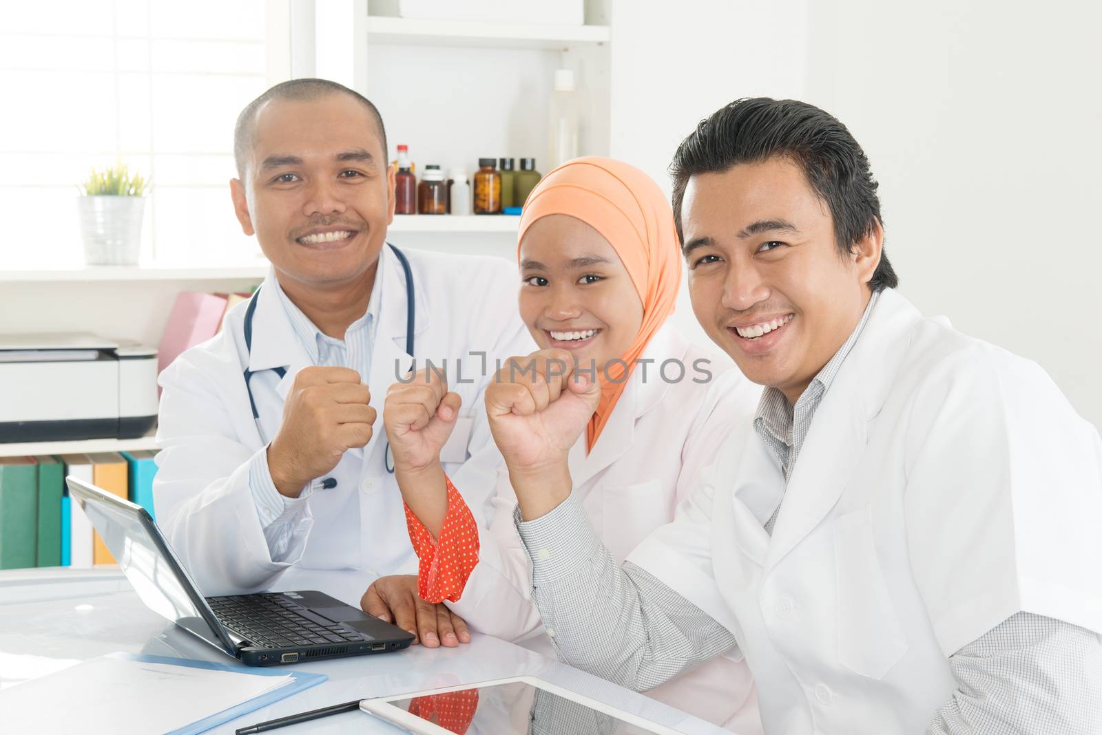 Asian doctors celebrating success by szefei