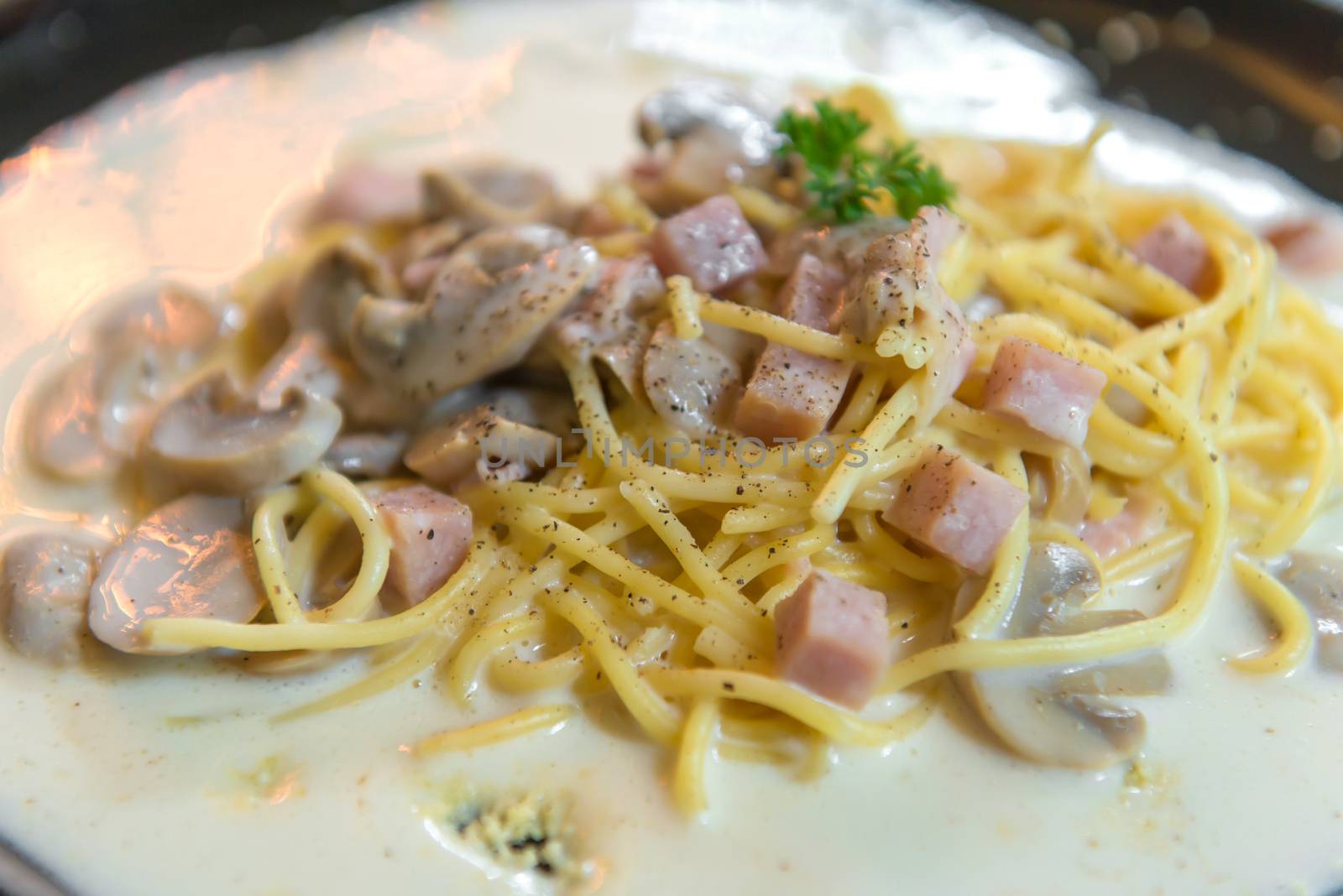 spaghetti with Mushroom sauce on black dish by casanowe