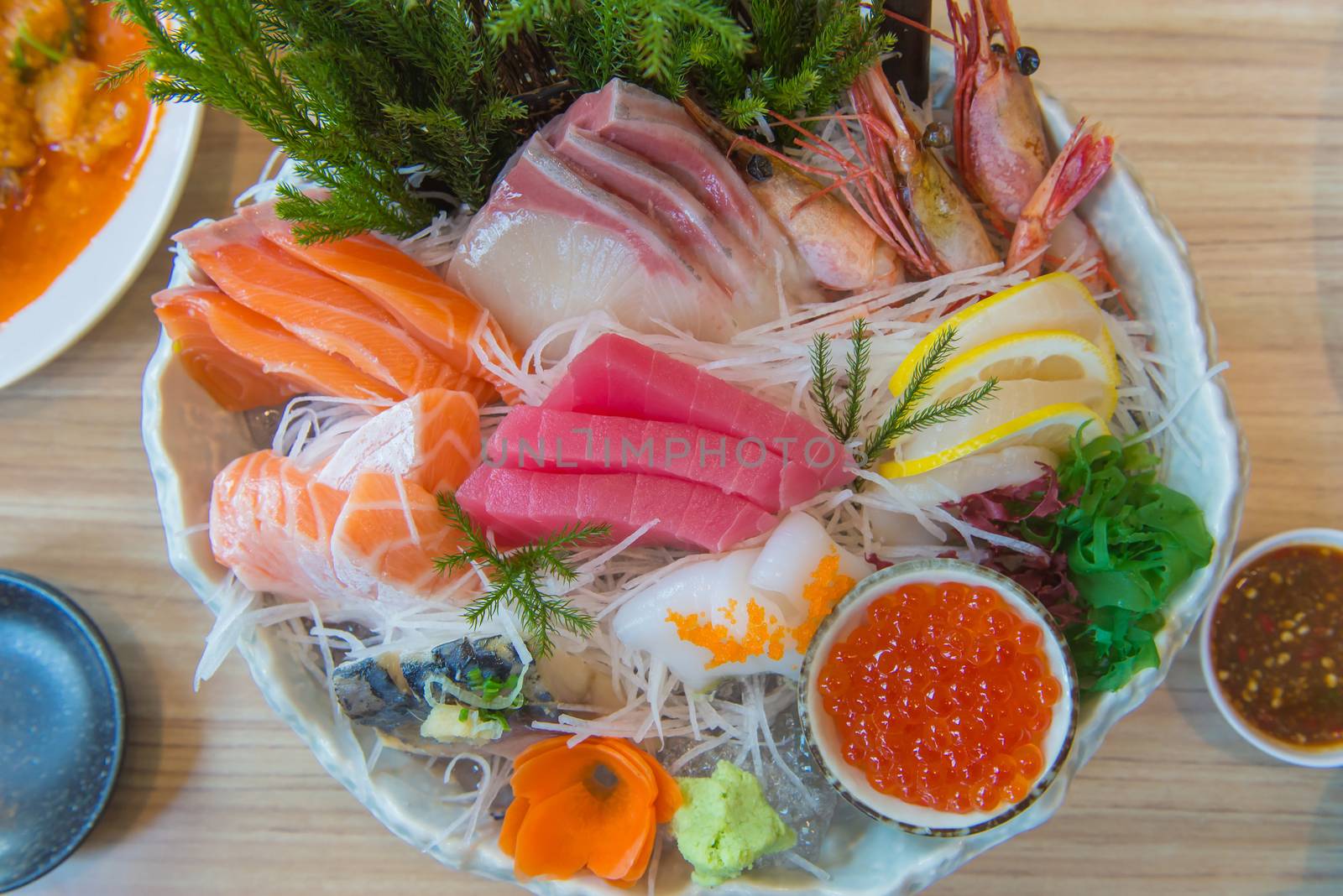 Salmon raw sashimi sushi with shrimp on plate, japanese food by casanowe