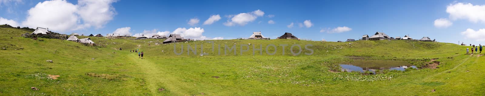 Extreme large panorama of Velika planina plateau, Slovenia, Mountain village in Alps, wooden houses in traditional style, popular hiking destination