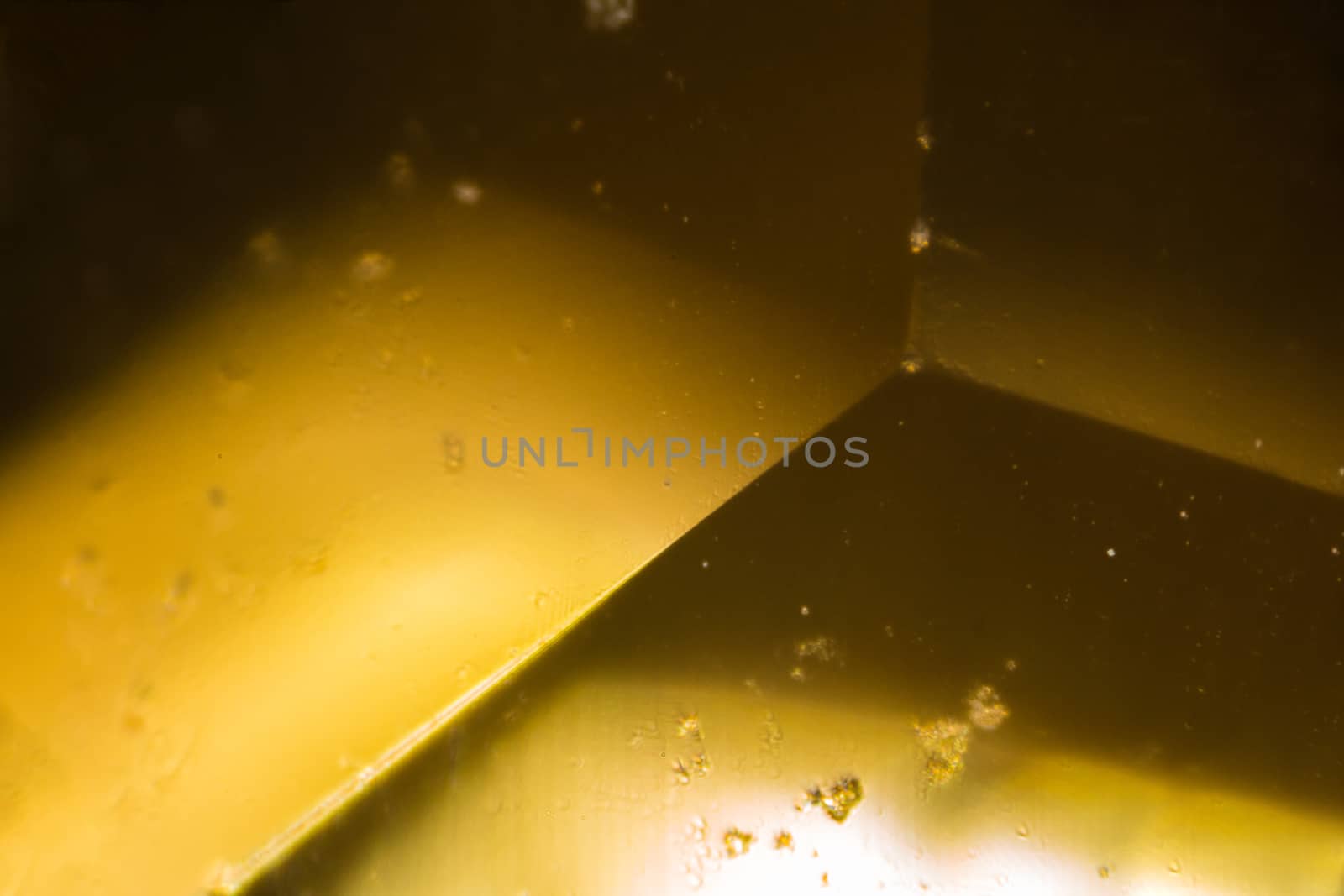 Yellow gem under the microscope. Closeup macro photography.