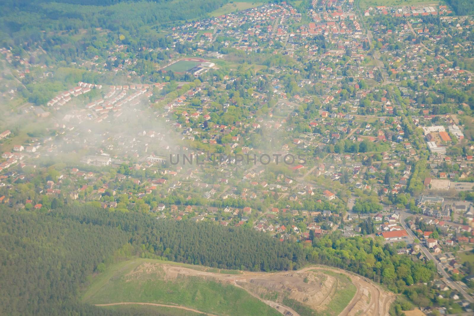 Aerial view over the small town and green area in Germany.