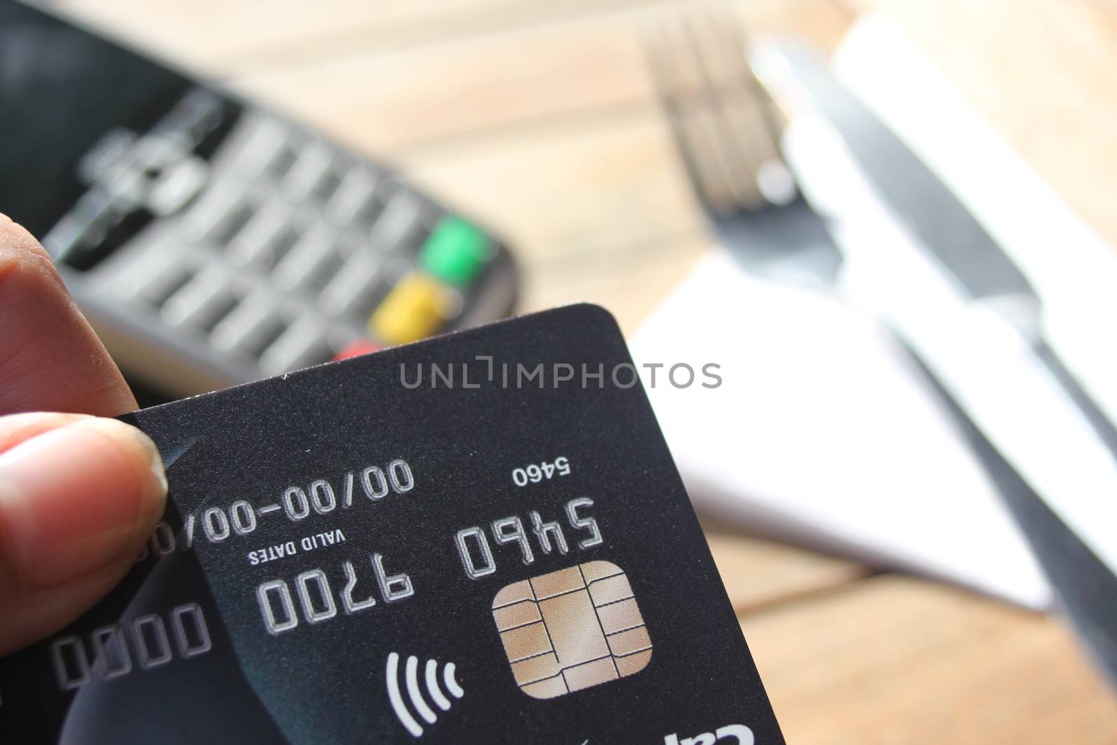 contactless payment card pdq background copy space with hand holding credit card to pay by cheekylorns