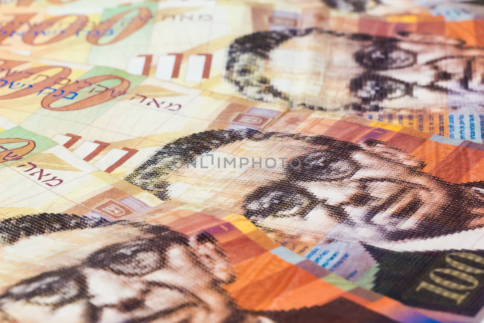 Stack of Israeli money bills of 100 shekel.