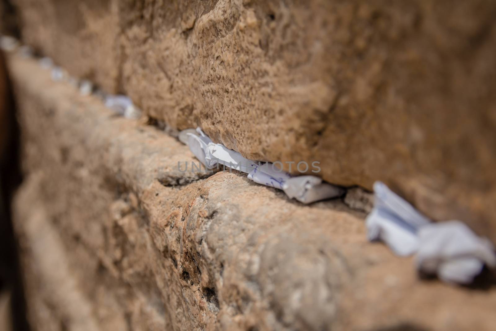 Notes to God in the cracks between the bricks of the Western Wall in the old city of Jerusalem Israel.