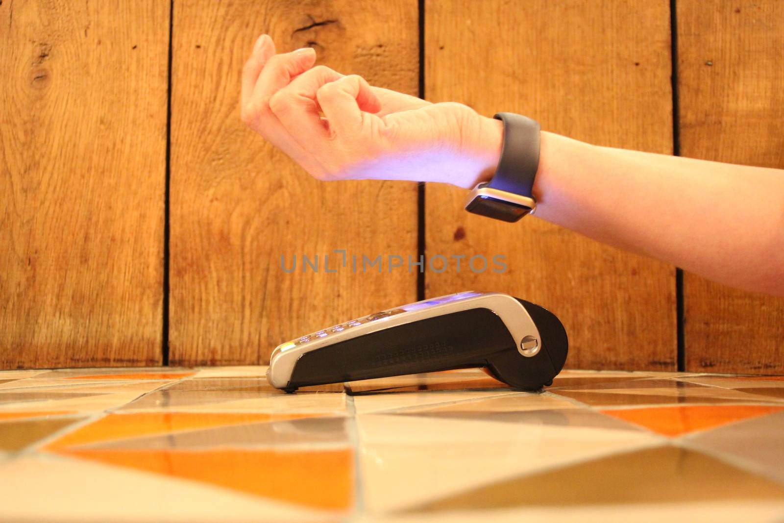 contactless payment apple watch pdq with hand holding credit card to pay by cheekylorns