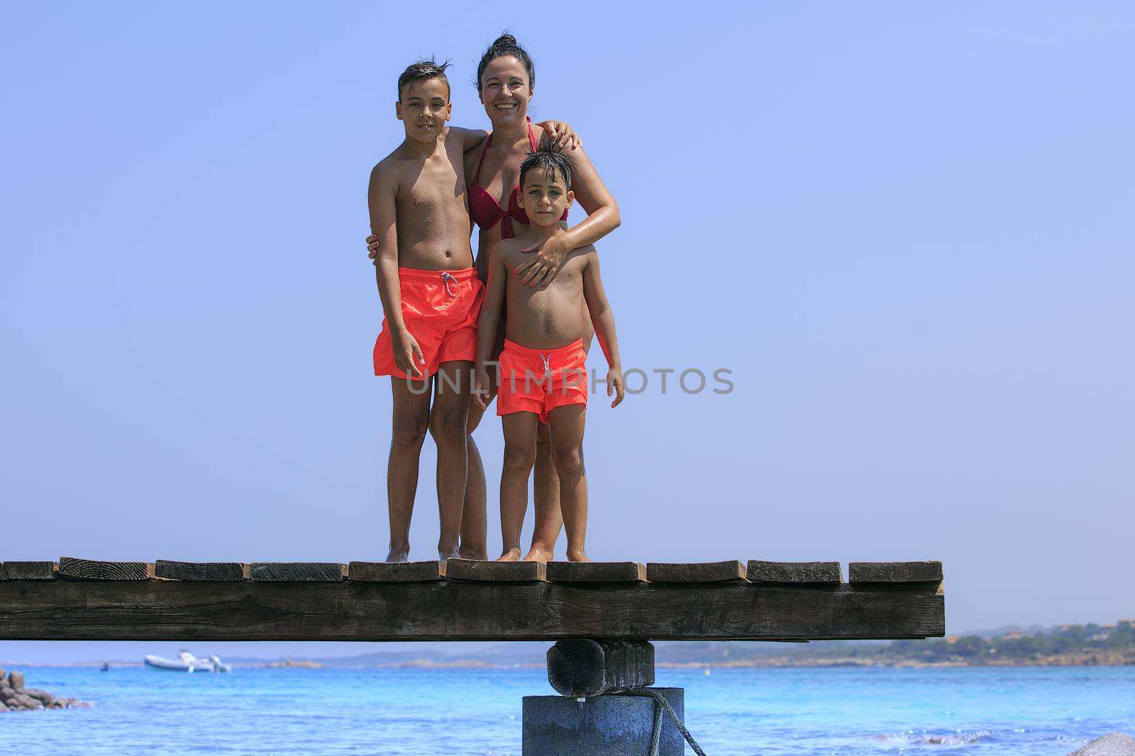 mother and her two sons on the beach