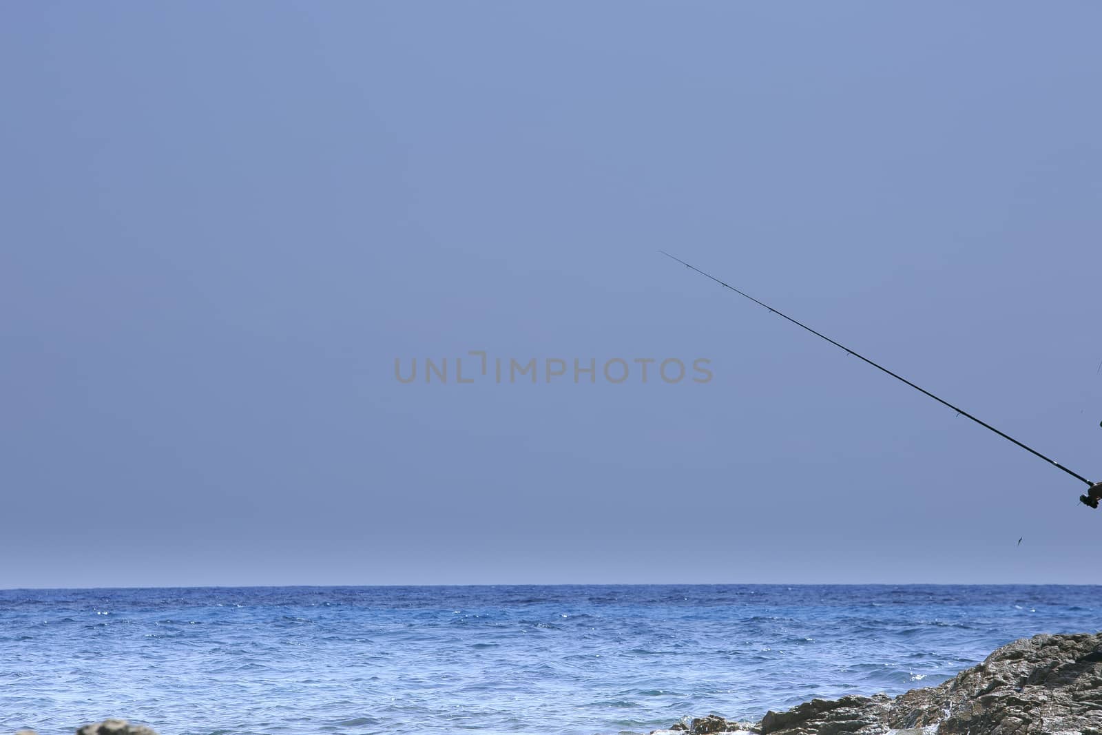 fisherman fishing on the coast of Sardinia