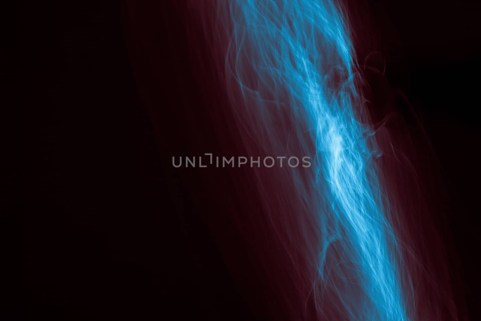 Light painted glowing abstract blue and red curved lines on a black background