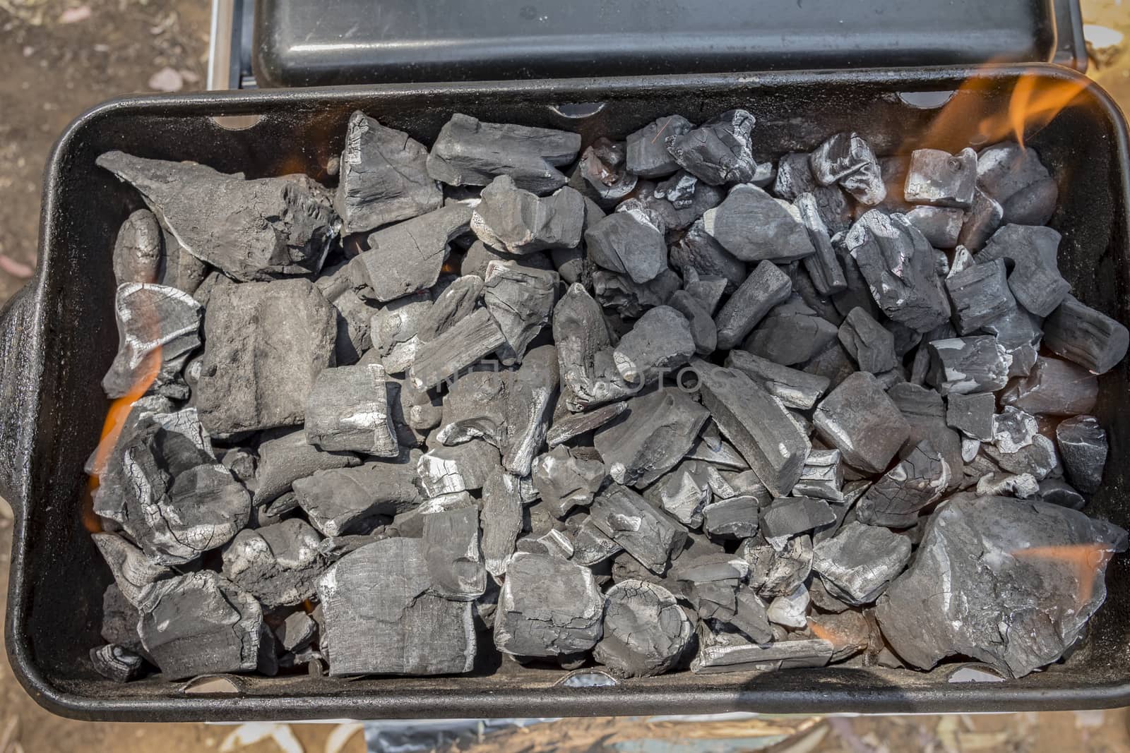 Coals are burned in a BBQ grill. Top view.