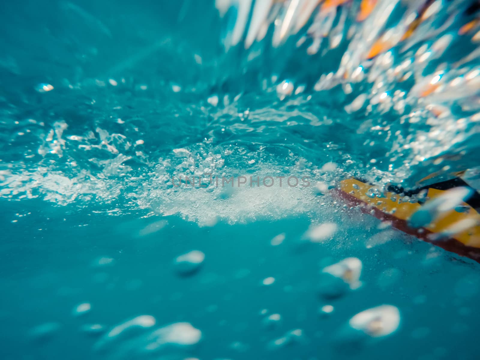 Underwater view of a moving inflatable ring that floating in the water.