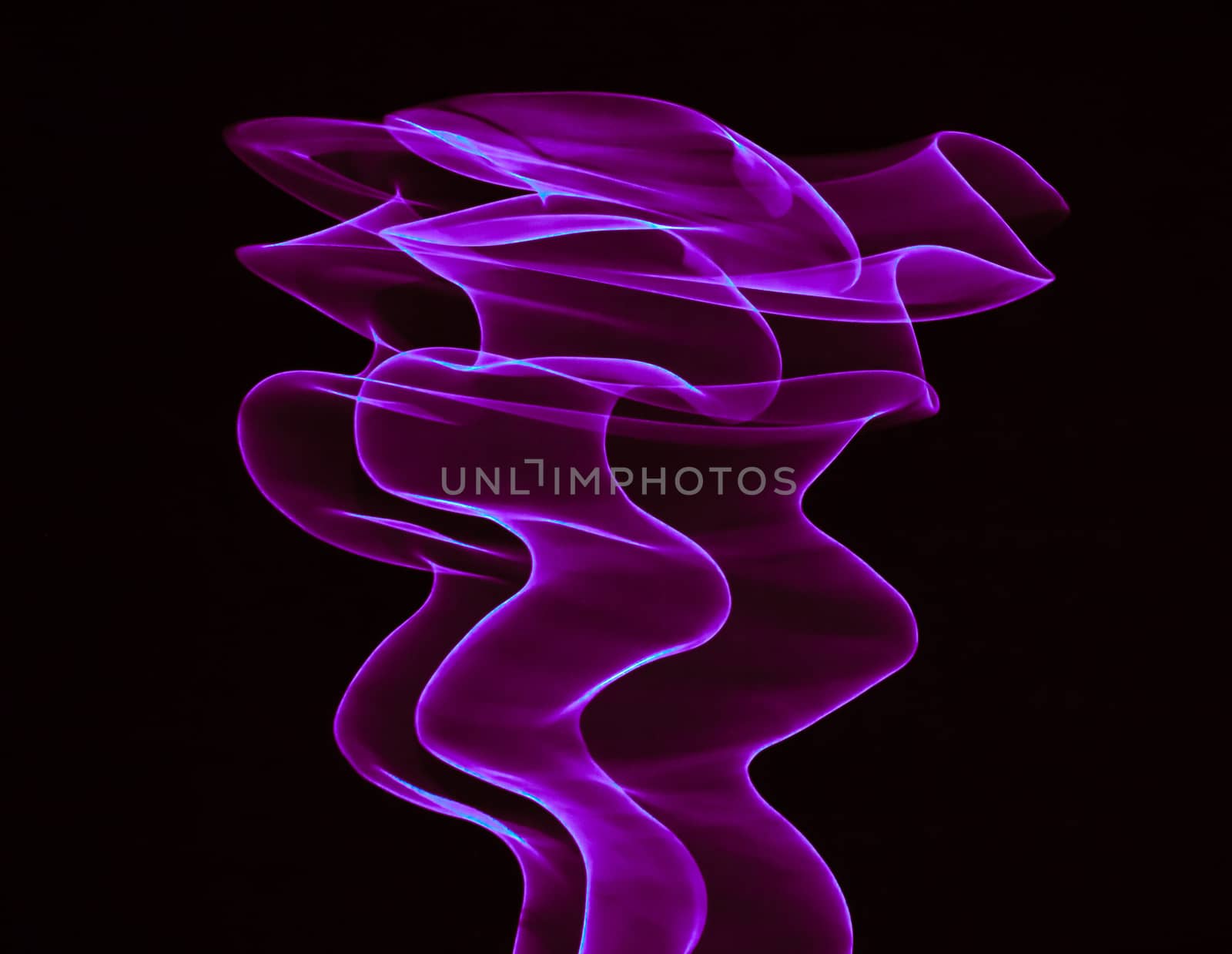 Glowing abstract curved lines.
Purple colors.
Black background.
Done by long exposure technique